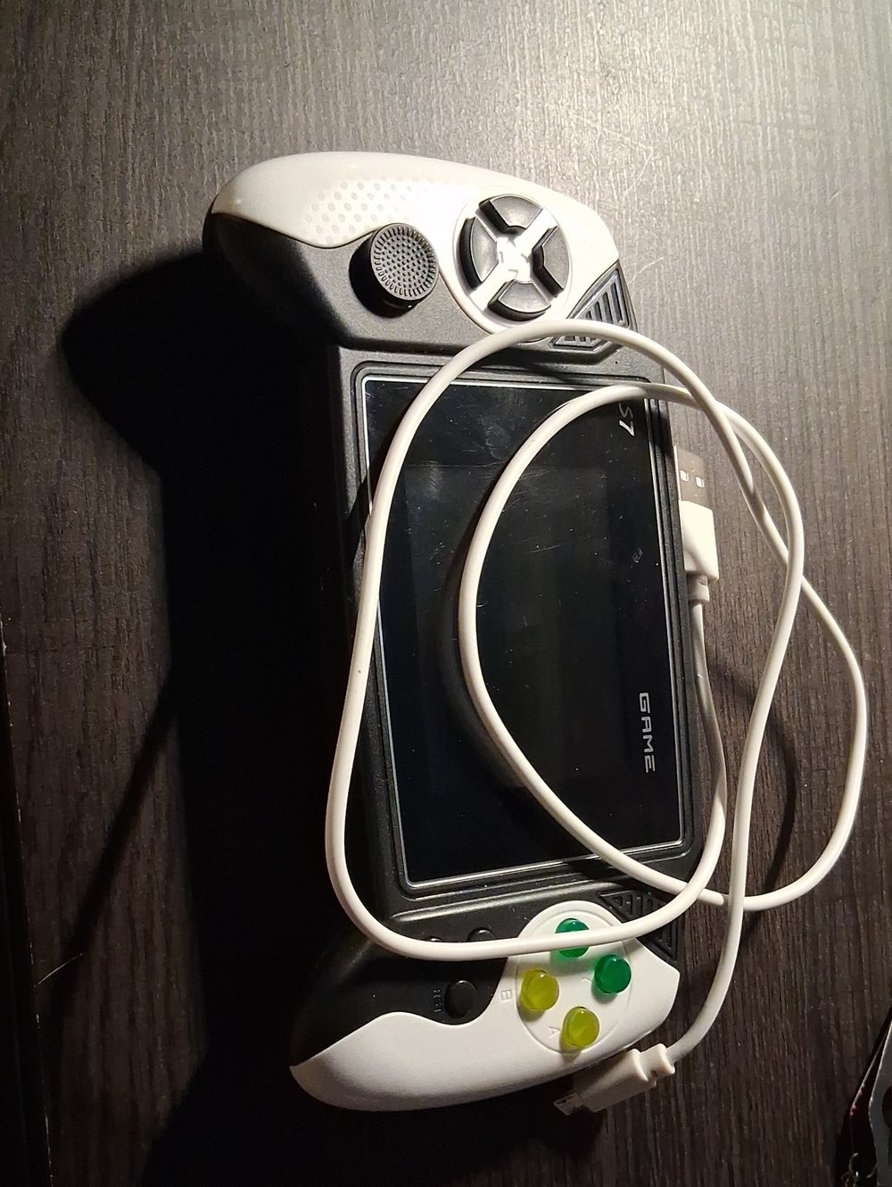 Source Unknown White Handheld Gaming Console with Green & Yellow Buttons